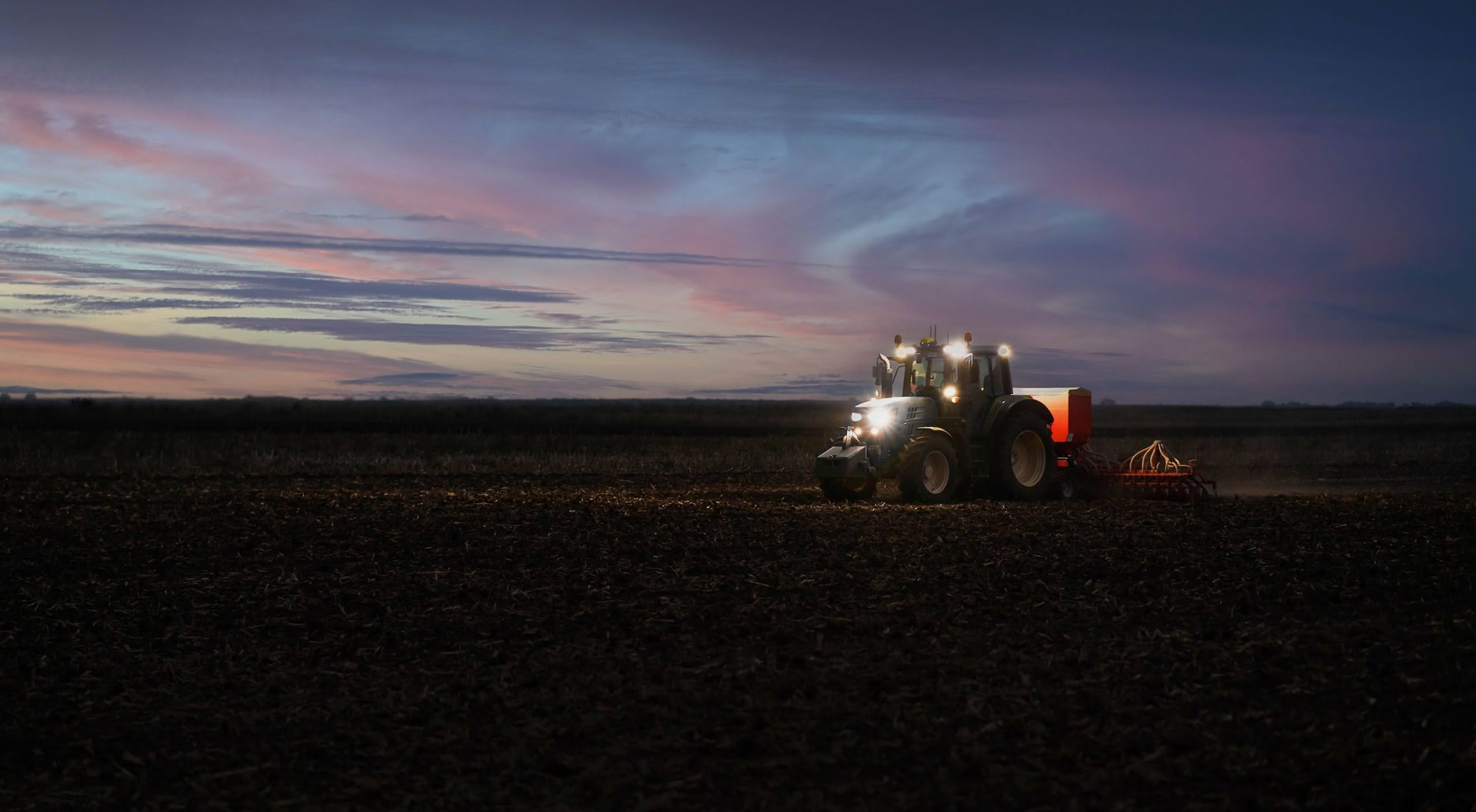 Tractor,Preparing,Land,With,Seedbed,Cultivator,At,Night.